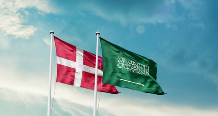 Denmark and Saudi Arabia friendship flags are waving in the sky. Two country flag for agreement or deal. Denmark KSA national flag for commitment.