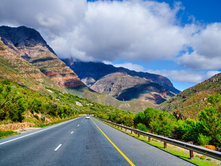 Naklejka premium Highway running through the Du Toitskloof Mountains on a cloudy day, South Africa