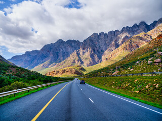Naklejka premium N1 Highway in shadow with sunlit Du Toitskloof Mountains, Western Cape, South Africa