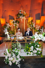 The bride and groom listen to congratulations and toasts from guests