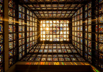 Low-Angle View of a Ornate Stained Glass Ceiling with a Sunburst, Church or Chapel Interior