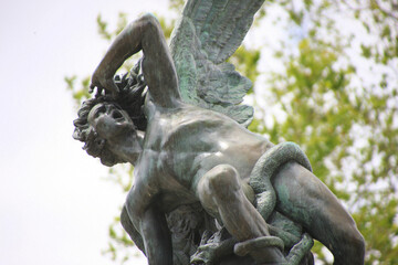Madrid. Fountain of the Fallen Angel. The sculpture in Retiro Park (Parque del Retiro) depicts the Fallen Angel (El Ángel Caído) being expelled from paradise. (Detail)