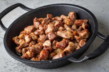 Muslims Traditional Sacrifice holiday food lamb, Turkish roasted meat in copper pot on table top. Turkish Kavurma. (Turkish name; Kurban kavurma)