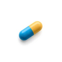 Single blue and yellow pill capsule isolated on white background