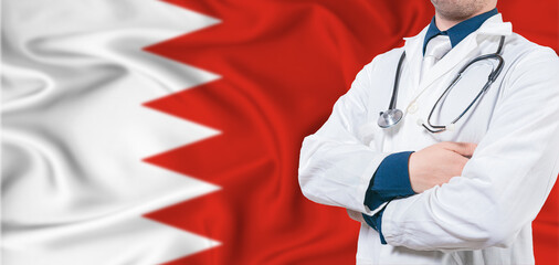 Bahrain healthcare concept. Male doctor on Bahrain flag. Doctor with crossed arms on Bahrain flag