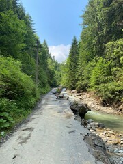 
flood in the mountains, destroyed road, mountain river
