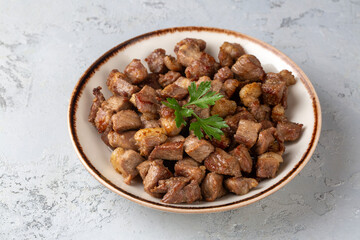Muslims Traditional Sacrifice holiday food lamb, Turkish roasted meat in copper pot on table top. Turkish Kavurma. (Turkish name; Kurban kavurma)