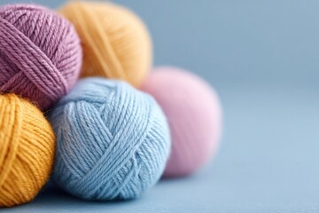 Soft yarn balls in pastel colors create cozy, inviting atmospher