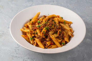 Penne pasta with minced meat and tomato sauce