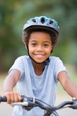 Obraz premium Smiling child on bicycle showcases joy and adventure in an outdo