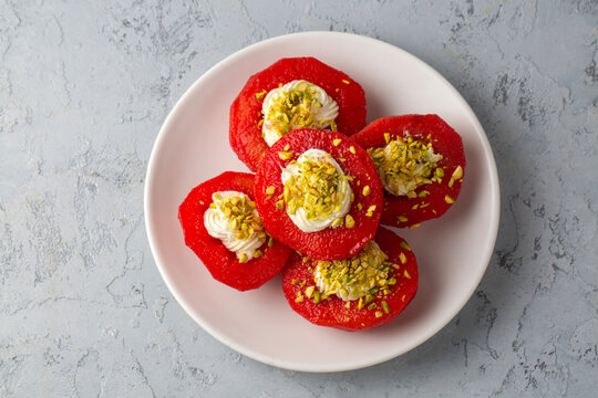 Traditional Turkish style quince dessert. The quince is cooked until soft, sherbet is poured on it, and served with cream and walnuts. It is one of the most popular Turkish desserts.(Ayva Tatlisi)