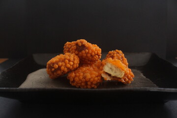 Tasty fried orange chicken nuggets with corn crumbs