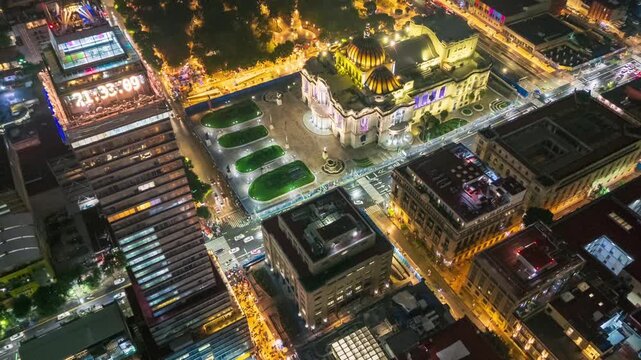 Stunning aerial night photo of downtown Mexico City showing illuminated skyscrapers and iconic buildings with vibrant lights. Urban architecture, culture and city life in a dramatic skyline view.