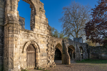 St. Leonard's Hospital ruins in York at golden hour with clear blue sky
