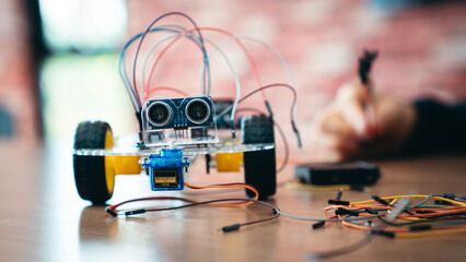 STEM Education Classroom With Obstacle Avoiding Robot Programming on Table, Back to School Robotics and Coding Project With Circuit, Wires, and Microchip Setup