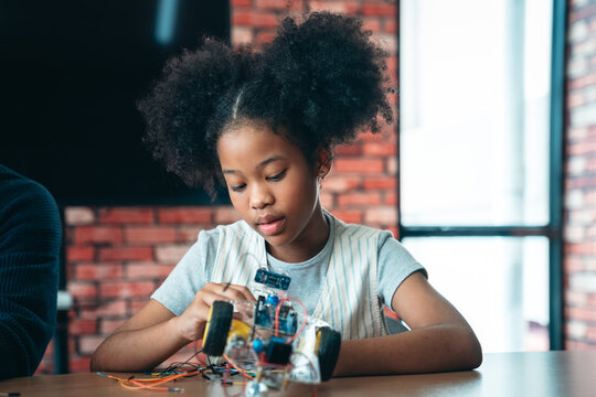 STEM Education Class With African American Girl Learning Robotics and Programming by Building Obstacle Robot in Back to School Technology Workshop