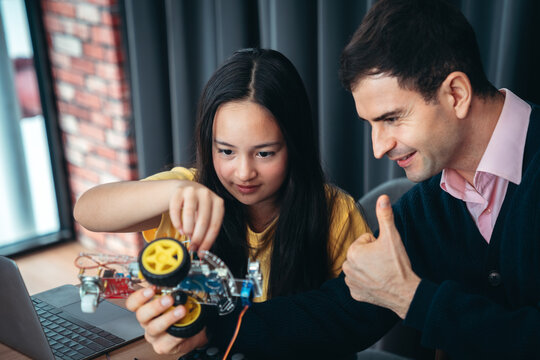 STEM Education Robotics Class for Girl Student Using Obstacle Avoiding Robot and Coding on Laptop With Guidance From Professional Engineering Instructor