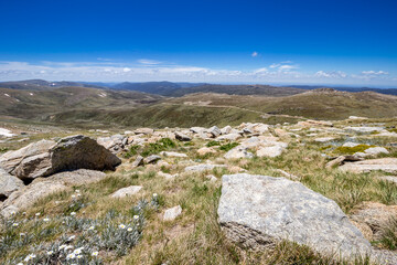 Breathtaking views from top of Mount Kosciuszko during a clear day, showcasing vast alpine landscapes and rugged terrain, Australia