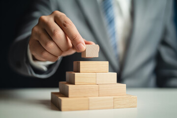 Building a solid business foundation with wooden blocks step by step achievement and growth concept
