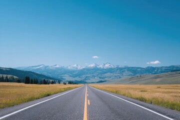 Naklejka premium Endless road stretches towards majestic mountains under clear bl