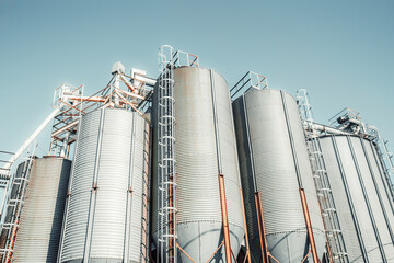 Industrial silos and machinery of a small-scale corn-based feed production plant in Campiello, Spain, with clean metal textures, bright lighting, and agricultural processing structures © skyNext