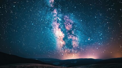 A stunning view of the Milky Way galaxy illuminating a dark night sky over rolling hills.