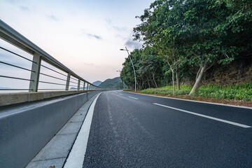 asphalt road side by sea