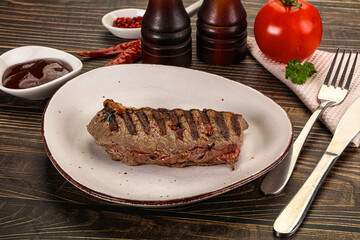 Grilled beef striploin steak with sauce