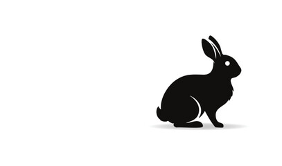 Obraz premium A Stylized Black Silhouette of a Rabbit Sitting in Profile on a White Background with a Subtle Shadow