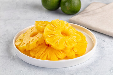 Sweet canned pineapple slices in syrope