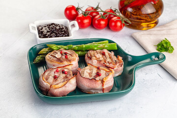 Tasty grilled pork medallion with bacon