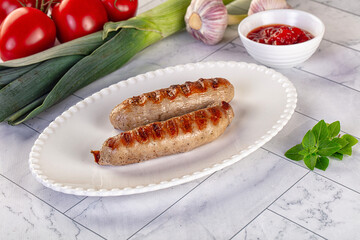 Grilled pork sausages served tomato sauce