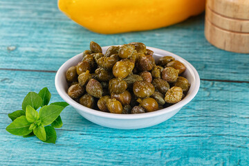 Pickled canned capers in the bowl
