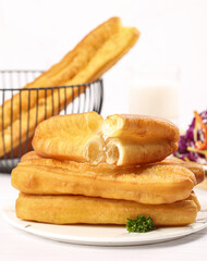 Crispy preparation of old fashioned big fries in a shallow bowl at a modern kitchen setting