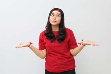 Indonesian women are confused between two choices, wearing red and white ribbons, standing while...