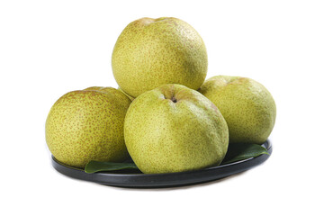 Fresh crown pears arranged on a black plate against a white background highlighting their vibrant texture and color