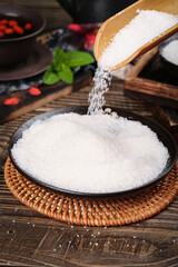 High-quality Yunnan white sugar poured into a bowl with natural ingredients for a refined culinary experience