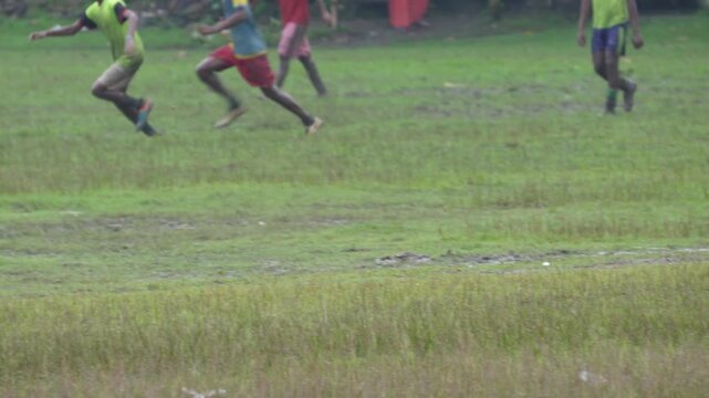 Soccer football players are running with the ball on ground for goals