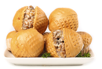 Wide walnut buns filled with brown sugar served on a white plate