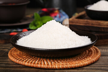 Fine white sugar from Yunnan sugar cane displayed in a traditional bowl on a woven mat