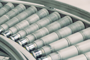 A close-up shot of a conveyor belt in an industrial setting, focusing on the details of its textured surface and the items being transported.