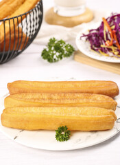 Crispy deep fried traditional small fries served with fresh coleslaw on a rustic table for breakfast delight