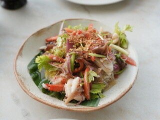 Seafood glass noodle salad with mixed vegetables, a delicious gourmet meal for lunch or dinner