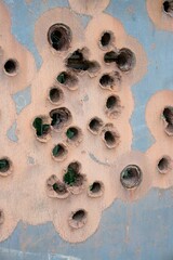 Rusty Thick Metal Surface with Bullet Holes Close-Up