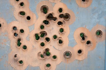 Rusty Thick Metal Surface with Bullet Holes Close-Up