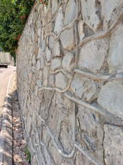 Decoration of the territory around the building. Fence made of natural stone