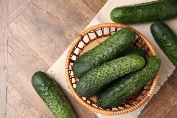 Fresh cucumbers on wooden table, flat lay