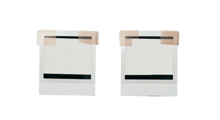Two identical, white, square photo frames, each with a strip of light beige tape across the middle and a blank, white inner surface