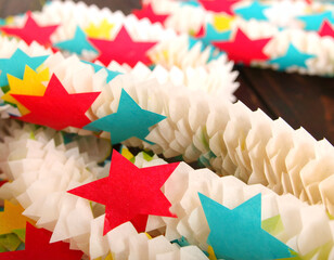 Colorful Paper Star Garland on Wooden Background