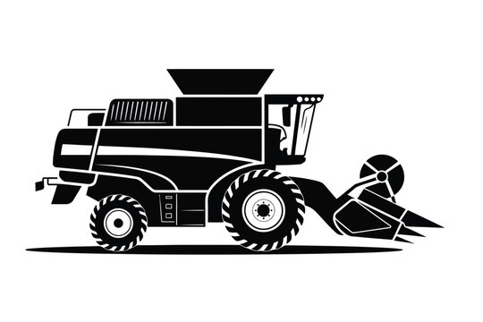 Black silhouette of a modern combine harvester in a field ready for harvest